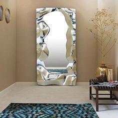 a mirror sitting on top of a wall next to a rug