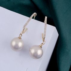 Expertly crafted with genuine pearls, these earrings radiate elegance and sophistication. Each earring boasts a unique, lustrous pearl, symbolizing wisdom and purity. The perfect accessory for any formal occasion or to add a touch of refinement to your everyday look. Classic Pearl Earrings For Parties, Elegant Pearl White Pearl Earrings For Party, Pearl Earrings For Evening, Elegant Pearl Pendant Earrings For Party, Pearl White Pearl Earrings, Evening Pearl Drop Crystal Earrings, Formal White Pearl Crystal Earrings, Round Pearl Pendant Earrings For Party, Pearl Drop Earrings For Party