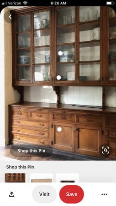 an old wooden china cabinet with glass doors