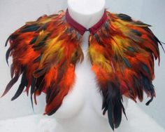 a white mannequin head with colorful feathers on it's chest and collar