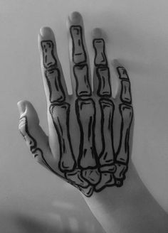 a person's hand painted with black and white ink, showing the skeleton bones