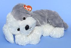 a gray and white stuffed animal laying down