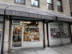 the storefront of kitchen arts and letters in front of a building with lots of windows