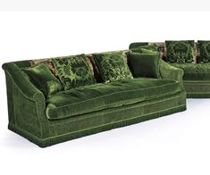 a green couch and loveseat sitting next to each other on a white background