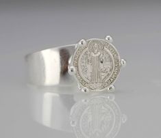 "This Beautiful and Traditional Saint Benedict ring made from high-quality Sterling Silver 925 Its the perfect gift for anyone of any age and excellent for everyday wear. Item Specifications: Model # PAS29M Metal Type: Sterling Silver Oxidize Metal Stamp: 925 Shape St. Benedict Style: Solid Medal Diameter: (approx 13mm-- 1/2 inch) Height from band (approx 8mm--- 5/16 inch) Band Width: Back: 5mm--- 3/16 inch Front: 9mm-- 3/8inch Stones: No * We only sell SOLID metals Stamp: 925 Sterling Silver. - Sterling Silver Open Band Signet Ring Gift, White Gold Open Band Signet Ring Gift, Silver Signet Ring With Open Band As Gift, Silver Open Band Signet Ring As Gift, St Benedict Cross, 15 Rings, St Benedict, Saint Benedict, Silver Prices