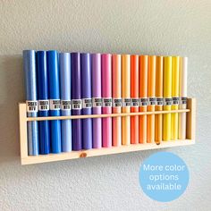 a wooden shelf with many different colored crayons on it and the words more color options available