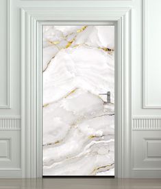 an open door with a white and gold marble pattern on the front, in a room