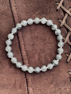 Hand made glass beads bracelet Gray Hand-strung Bracelets With Round Beads, Silver Glass Bracelets With Round Beads, Gray Stretch Bracelet With Round Beads For Gifts, Gray Round Beads Stretch Bracelet As Gift, Gray Faceted Beaded Bracelets As Gift, Gray Faceted Beads Bracelet As Gift, Gray Faceted Beads Bracelet For Gift, Gray Beaded Bracelets With Faceted Beads As A Gift, Gray Faceted Beaded Bracelets For Gifts