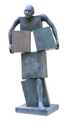 a sculpture of a man holding two blocks