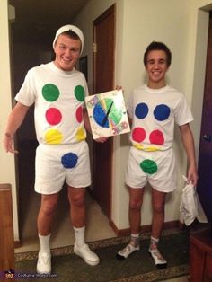 two people dressed up as clowns in the hallway