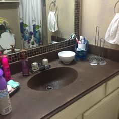 a bathroom sink with soap, toothbrushes and other personal care items on it