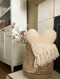 Woven seagrass basket + heart shaped throw pillow + white throw blanket + faux pink floral stems Valentines Day Farmhouse Decor, Valentines Interior Design, February Home Decor Ideas, Valentine’s Day Apartment Decor, Aesthetic Valentines Day Decor, Valentines Decor Aesthetic, Valentine Bedroom, Valentine’s Day Bedroom