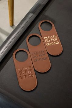 three luggage tags that say please don't disturb