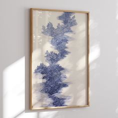 a blue and white painting hanging on the wall