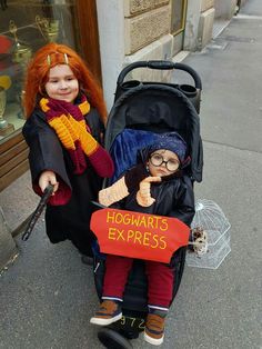 two children dressed up as harry potter and her doll in a stroller on the sidewalk