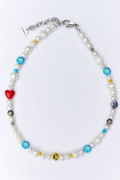 THE RIMOR AESTAS MELER CHOKER combines genuine freshwater pearls with fun ceramic, glass and gemstone beads. Handmade in the brand’s Los Angeles studio, this piece will become your new everyday favorite. Content + Care Genuine Freshwater Pearls, Flower Glass Beads and Genuine Gemstones, Ceramic Smiley Bead, Lock in Stainless Steel Remove necklace when going in water. Clean pearls with a soft cloth USA Size + Fit 15 Inches or 18 Inches | RIMOR JEWELRY RIMOR Aestas Meler Pearl Choker Necklace, Men Smiley Face Necklace Beads, Choker Necklace Men, Smiley Face Necklace, Face Necklace, Necklace Beads, Necklace Men, Pearl Choker Necklace, Beads Handmade, Pearl Choker