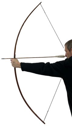 a man in black shirt holding an arrow and aiming it at the target with both hands