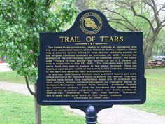 the trail of tears marker in front of trees