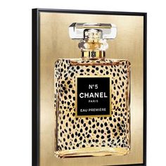 a bottle of chanel no 5 perfume in gold and black with a leopard print on it