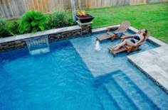 a small backyard with a pool and fire pit