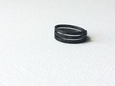 Minimal Iron Ring, Simple Black Ring, Plain Handmade Ring, Dark Grey Ring, Metal Rustic Ring, Raw Wire Ring, Unisex Steel Band, Women Band This simple 3 story iron ring was handmade from an iron wire. Minimal, a little masculine. For someone who likes a little bit of edge. For someone bored with shiny polished girly style rings.  Let me know what size you need! I'll create one just for you. Ring will be packed in a linen satchet and shipped to you in a bubble envelope as soon as possible.  Mater Adjustable Black Rings For Everyday Wear, Minimalist Adjustable Black Rings, Minimalist Handmade Black Ring, Black Adjustable Stackable Rings, Adjustable Black Stackable Rings, Adjustable Black Stackable Open Rings, Grey Ring, Gray Ring, Rustic Ring