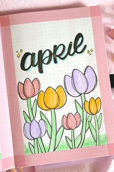 an open notebook with flowers on it and the word aprre written in cursive writing