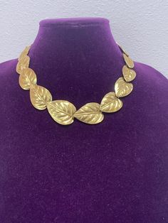 Lovely vintage Trifari gold tone graduated leaf necklace/choker with shepherd hook clasp and a smaller gold leaf at the end. The necklace has a built in curve to lay perfectly on the neck.  The approximate maximum length is 18 inches. Excellent condition, like new! It comes from a private collection. PLEASE look at ALL pictures for measurements and condition as they are a very important part of the description, and what you will receive! Pictures are made with different light! Please note that this is sold "As Is", no returns please! Luxury Vintage Brown Necklace, Leaf-shaped Yellow Gold Necklace, Elegant Gold-tone Brass Choker, Vintage Gold-tone Brass Necklace, Vintage Gold Leaf-shaped Jewelry, Vintage Trifari, Choker Collar, Hook Clasp, Fall Jewelry