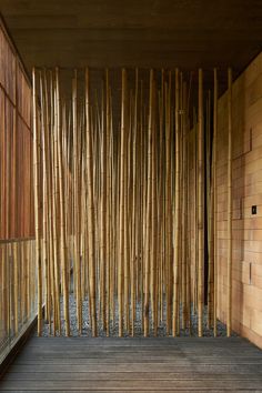 a room with bamboo walls and wooden flooring