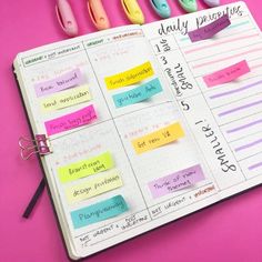 a planner with sticky notes attached to it and some markers on the page next to it