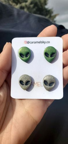 the alien head earrings are green and black