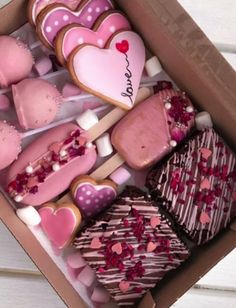 a box filled with lots of heart shaped cookies