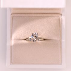 an engagement ring in a gift box