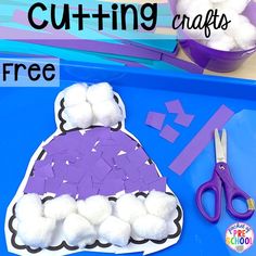 a paper plate with cotton balls and scissors next to it on a blue tray that says cutting crafts free