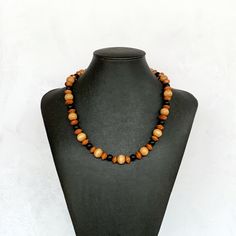 "This short wood necklace is perfect for everyday wear!  It was hand beaded using a mix of 10mm round distressed light brown wood beads, 7mm round matte black beads, and geometric mocha wooden beads.  Simple, yet stylish!  The necklace measures approximately 20 inches in length and is securely fastened with a silver clasp.  Modern boho feel!  Length can be adjusted if needed - just ask! Wood represents a sense of earthiness, spirituality, creativity, liberty, prosperity, health, and natural touch.  Perfect for meditation, prayer, yoga practices, and everyday wear!    Check out more fabulous jewelry and enter my shop here: https://www.etsy.com/shop/jewelbytessyla View the positive feedback I've received from customers and check out some beautiful art prints for nursery and home at my print Everyday Brown Wooden Beaded Necklaces, Wooden Bead Necklace, Mens Beaded Necklaces, Necklace Everyday, Necklace Wood, Wooden Bead Necklaces, Necklace Mens, Mens Necklace, Wood Bead Necklace