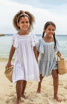 This playful cover-up will be your little one's favorite beach accessory thanks to swingy tassels tracing the layered flutter sleeves and ladder-stitched hem. Slips on over head UPF 50+ sun protection 100% viscose Hand wash, line dry Imported Playful Ruffle Sleeve Beach Dress, Summer Flutter Sleeve Dress For Playwear, Summer Playwear Dress With Flutter Sleeves, Summer Flutter Sleeve Dress For Vacation, Playful Summer Dress With Flutter Sleeves, Beach Dress With Ruffle Hem, White Flutter Sleeve Beach Dress, Playful Ruffled Dresses For Vacation, Summer Beach Dress With Flutter Sleeves