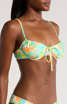 Dainty ties mark the center of this underwire bikini top with a colorful pattern that summons sunny-day energy. Clasps at back Lined Adjustable straps 88% polyester, 12% elastane Hand wash, dry flat Imported Beach Swimwear With Knotted Straps And Underwire, Underwire Swimwear With Knotted Straps For Beach, Underwire Floral Print Swimwear, Floral Print Underwire Swimwear, Beachwear Swimwear With Knotted Straps And Underwire, Underwire Beachwear Swimwear With Knotted Straps, Underwire Beachwear With Knotted Straps, Underwire Swimwear With Knotted Straps For Pool, Underwire Swimwear With Knotted Straps For Sunbathing