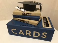 a stack of books with a graduation cap on top