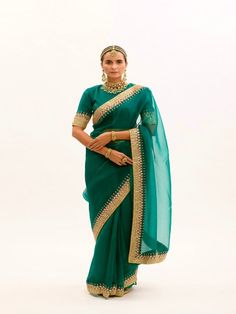 Featuring an Emerald Green Saree in silk organza base with hand embroidered gota and marodi Border. It is paired with matching Modal Satin Petticoat and Silk Stitched Blouse having having makes and gota embroidery. Fabric: Pure Silk Organza, Habutai Silk, Pure Modal Satin Lining Fabric - Cotton Color: Green Emboridery & Embellishments: Gota, Mukeish and marodi work Blouse Neck: Crew / Jewel neck Fit: Fitted at bust and waist Note: The product will be delivered within 3-4 weeks of the order place Emerald Green Saree, Marodi Work, Gota Embroidery, Gota Patti Saree, Purple Saree, Yellow Saree, Purple Hands, Blouse Neck, Black Saree