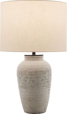 a large gray vase with a beige shade on it's side and a white lamp in the middle