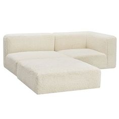 a white couch sitting on top of a white floor