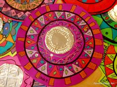 colorful paper plates with designs on them sitting on a table