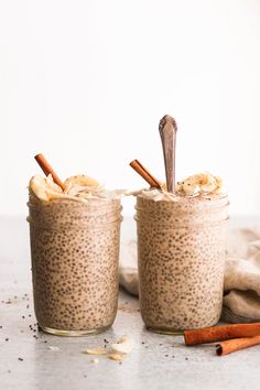 two jars filled with chia pudding and cinnamon sticks