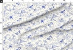 a blue and white toiler print fabric with an animal pattern on the side