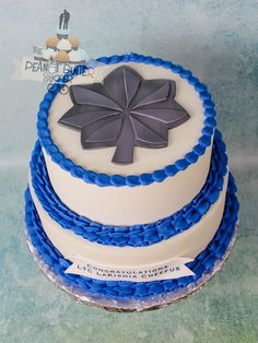 a three layer cake with blue and white frosting