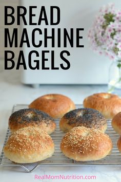 six bagels on a cooling rack with flowers in the background