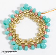 the beaded bracelet is made with gold and turquoise beads