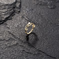 a gold ring sitting on top of a rock