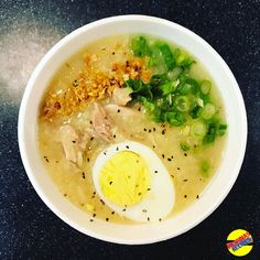 a bowl of soup with an egg and green onions