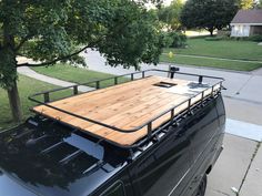 a black van with a wooden deck on the back