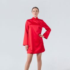 "A modern qipao dress featuring a loose silhouette, mini length and a high neck collar. - modern cheongsam style - mandarin neck - loose silhouette - above the knee length (mini) - loose long sleeves - back metal zipper closure - lined bodice Color: red Fiber: viscose - 40%, elastane - 5%, polyester - 55% Lining: viscose - 95 %, elastane - 5% For Size S: dress length - 33,5\"(85 cm), sleeve length - 23,6\" (60 cm) Our model wears size S (US 6) and is 171cm/5'7\" tall. MORE DRESSES: https://www.e Elegant Winter Dress With Stand Collar, Elegant Knee-length Ao Dai For Party, Winter Evening Dress With Stand Collar, Elegant Long Sleeve Cheongsam For Evening, Elegant Long Sleeve Formal Cheongsam, Elegant Long Sleeve Cheongsam, Elegant Formal Long Sleeve Cheongsam, Formal High Neck Mini Dress, Elegant Long Sleeve Evening Cheongsam